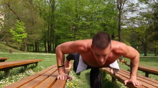 Człowiek robi pompki na ławce — Wideo stockowe