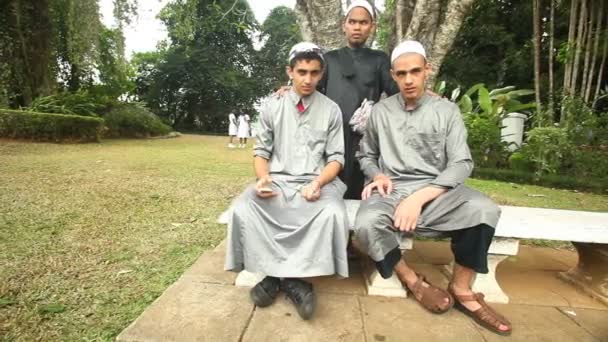 Muslim men posing in the botanical gardens — Stock Video