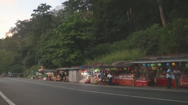 Road to Kandy with many street stalls and heavy traffic in the evening. — Stock Video