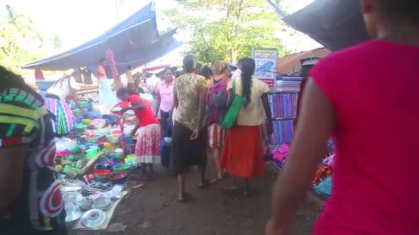 Locals passing by at Hikkaduwa market — Stock Video