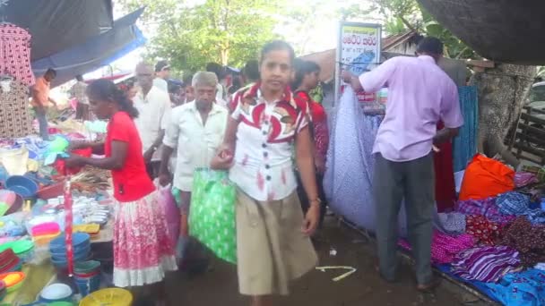 Locals passing by at Hikkaduwa market — Stock Video