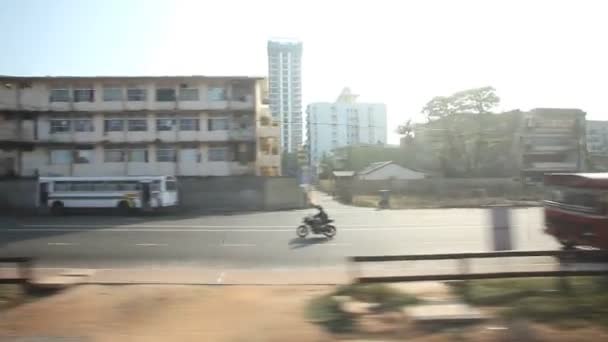 View of Colombo city traffic from passing train. — Stock Video