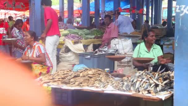 Locals selling and people passing by at Hikkaduwa market. — Stock Video