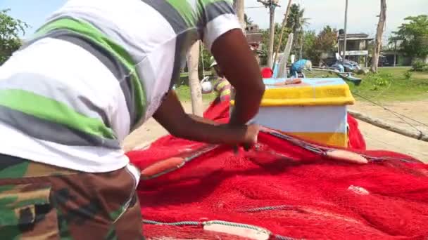 Close up of local fisherman sorting nets — Stock Video