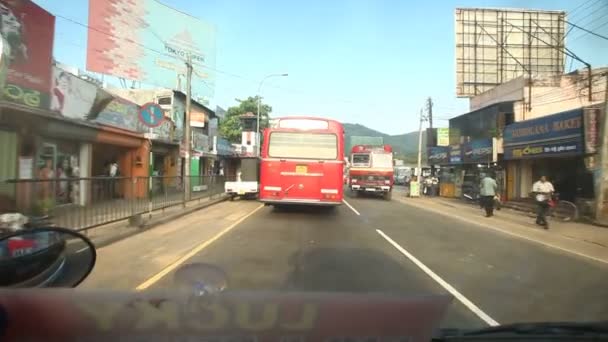 Conducir detrás de un autobús rojo en Kand — Vídeo de stock