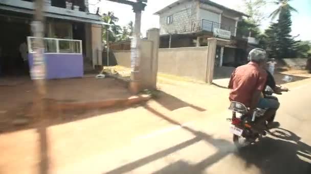 Two men on motorcycle in traffic — Stock Video