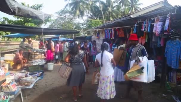 Locals passing by at Hikkaduwa market — Stock Video