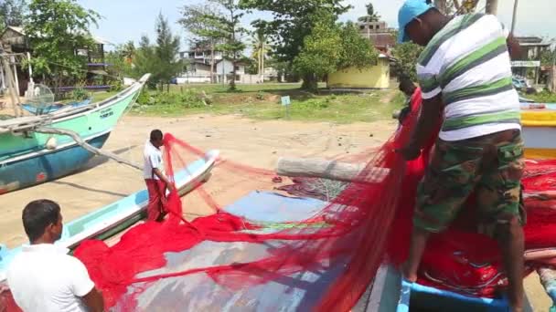 Close up of local fisherman sorting nets — Stock Video