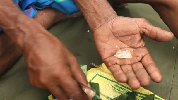 Man preparing paan or betel nut or areca nut mix — Stock Video