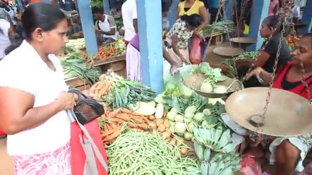 Vrouwen verkopen en mensen kopen bij Hikkaduwa markt — Stockvideo