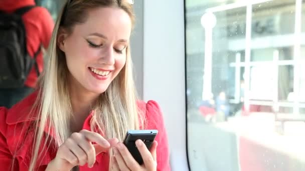 Vrouw in tram te typen op mobiele telefoon — Stockvideo