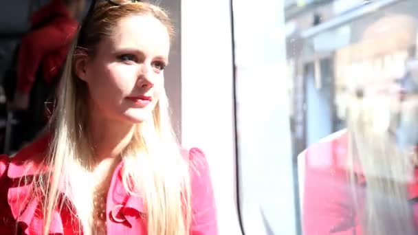 Woman looking out and smiling on tram — Stock Video