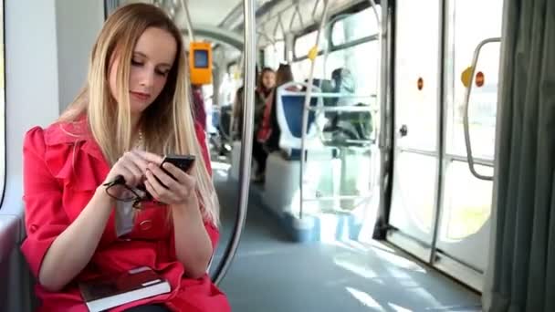 Woman using mobile phone on tram — Stock Video