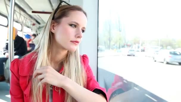 Woman riding in the tram and looking out the window — Stock Video