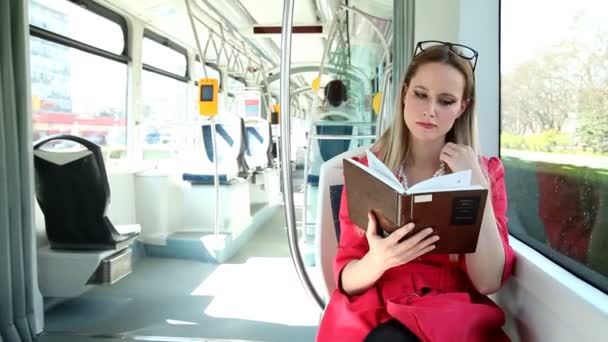 Mujer leyendo libro en tranvía — Vídeo de stock