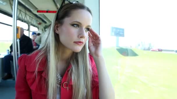 Woman riding in the tram and looking out the window — Stock Video