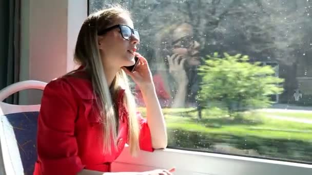 Woman talking on mobile phone on tram — Stock Video