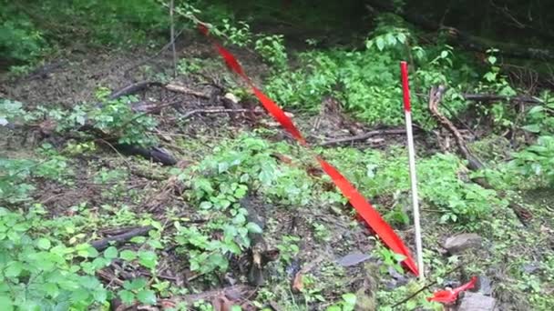 Area of demining marked with red tape — Stock Video