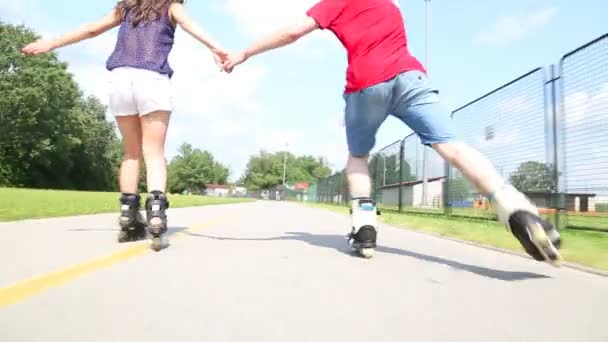 Young woman and man rollerblading — Stock Video