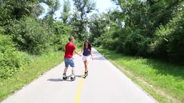 Mujer y hombre patinando en un día soleado en el parque — Vídeos de Stock