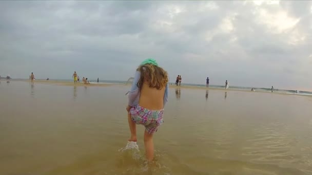 Meisje wandelen aan het zandstrand — Stockvideo