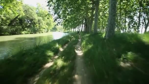 Cycling on track next to Canal — Stock Video