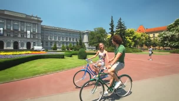 Paar genieten van fietsen door park — Stockvideo