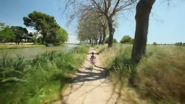 Little girl running along path track — Stock Video