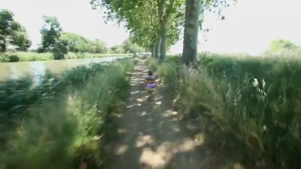 Little girl running along path track — Stock Video