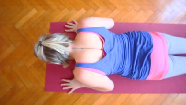 Woman doing yoga on rubber mat — Stock Video