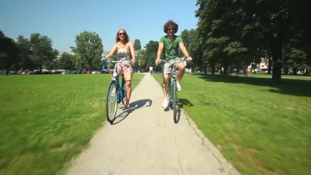 Pár, kteří požívají, jízda na kole přes park — Stock video