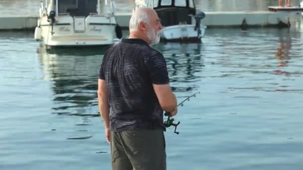 Pescador en el casco antiguo del puerto de Krk — Vídeos de Stock