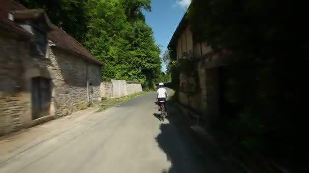 Woman cycling on road — Stock Video