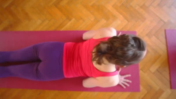 Woman doing yoga on rubber mat — Stock Video