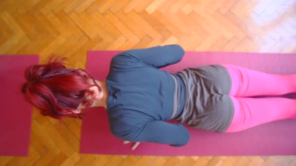 Woman doing yoga on rubber mat — Stock Video