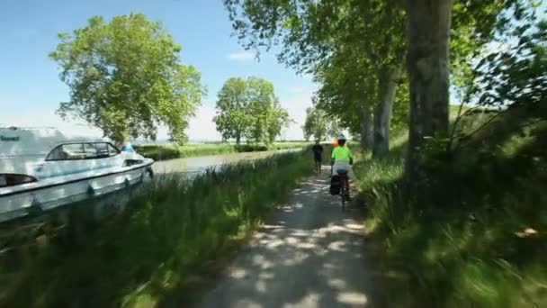 Retired couple cycling beside river — Stock Video