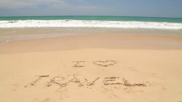 Ocean wave covering words I love travel written in sand on beach — Stock Video