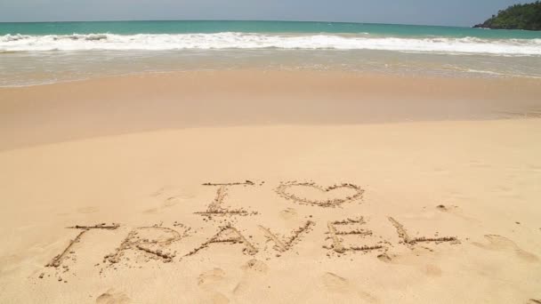 Ocean wave approaching words I love travel written in sand on beach — Stock Video