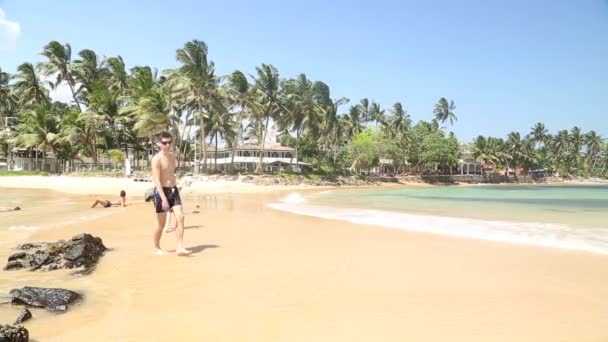 Pessoas andando na praia arenosa . — Vídeo de Stock