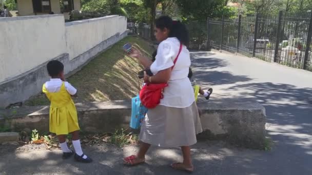 People and kids standing near the Temple of the Tooth — Stock Video