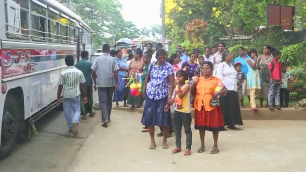 Lokalbefolkningen står vid busstationen nära botaniska trädgården i Kandy. — Stockvideo
