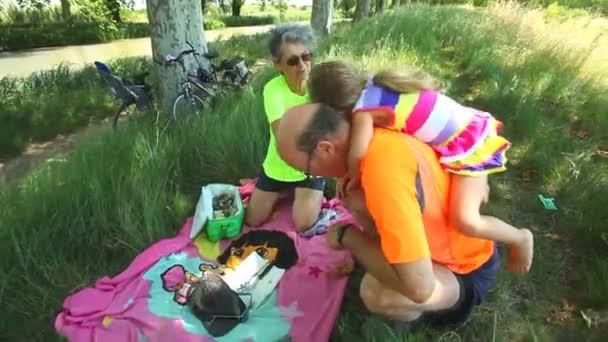 Abuelos disfrutando de picnic con su nieta — Vídeo de stock