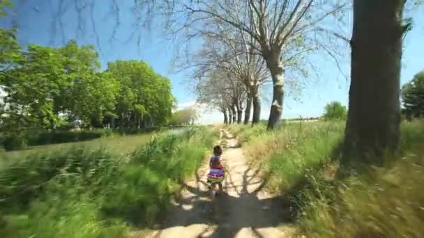 Girl running along path track — Stock Video