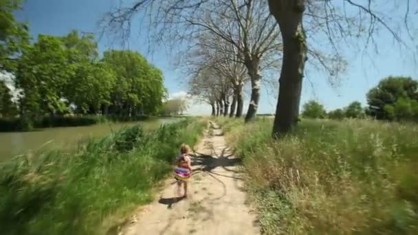 Girl running along path track — Stock Video