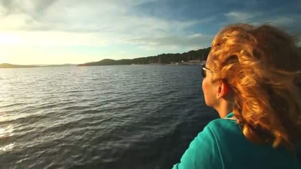 Woman sitting on bow of sailing boat — Stock Video