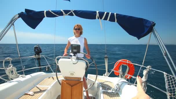 Woman at wheel steering sailboat — Stock Video