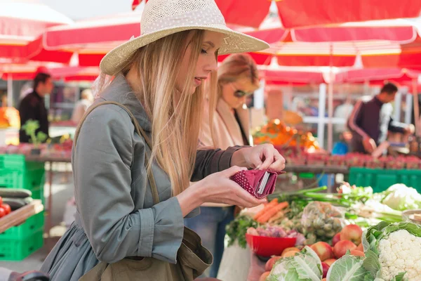 Atractiva chica rubia con sombrero de paja posando en el mercado de flores . —  Fotos de Stock