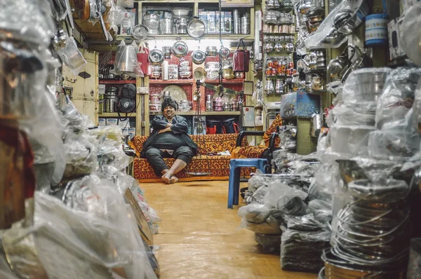 Indian shop owner sitting on couch — Stock Photo, Image