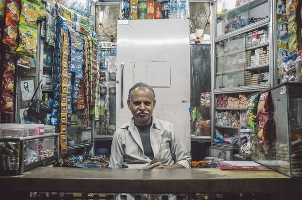 Vendedor indiano senta-se na loja — Fotografia de Stock