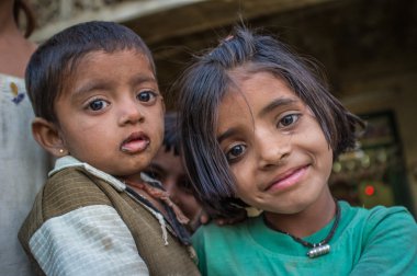 Young girl holds baby.